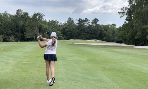 Advanced Junior golf on course.